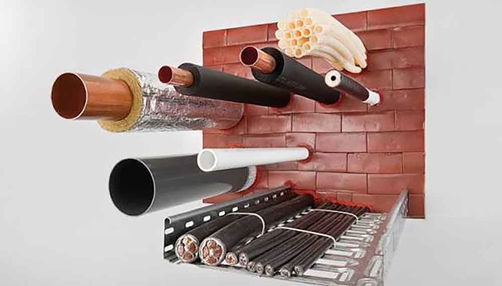 Code-Compliant Firestopping Installation Firestopping system installed around pipe and cable penetrations in a rated wall assembly.