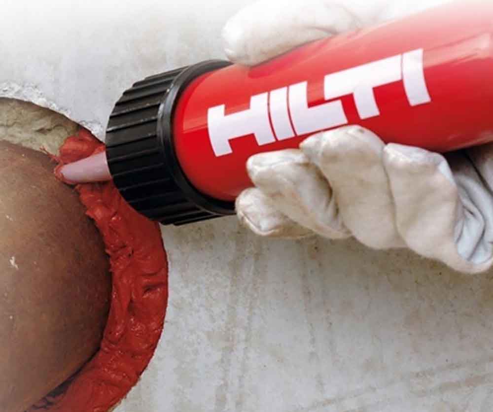 Commercial Firestopping Sealant Application Application of firestop sealant around pipe penetration in a rated wall assembly.